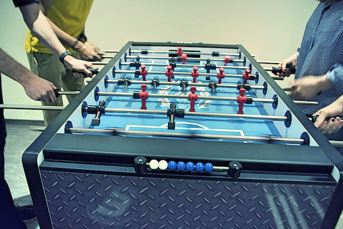 Neos IT Services, working environment, employees playing table football